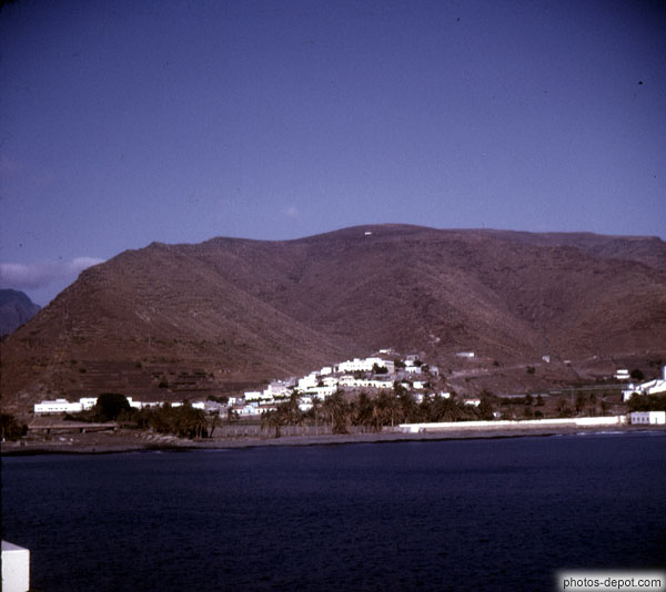 photo de village sur colline devant mont pelé