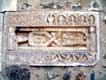 Pierre sculptée tombeau sur le mur du Cloître