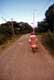 Femme marche sur la route / Nouvelle Calédonie, Ile des Pins
